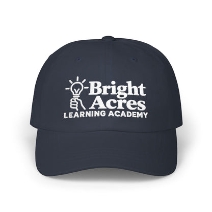Bright Acres navy dad cap with white embroidered school logo, front